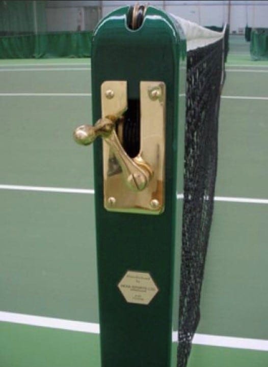 sunny tennis court infront of building