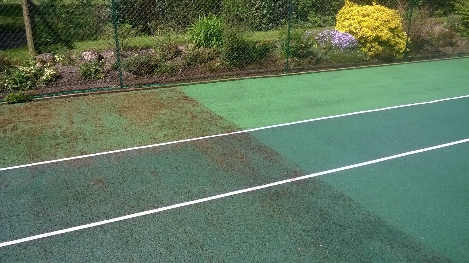 sunny tennis court infront of building