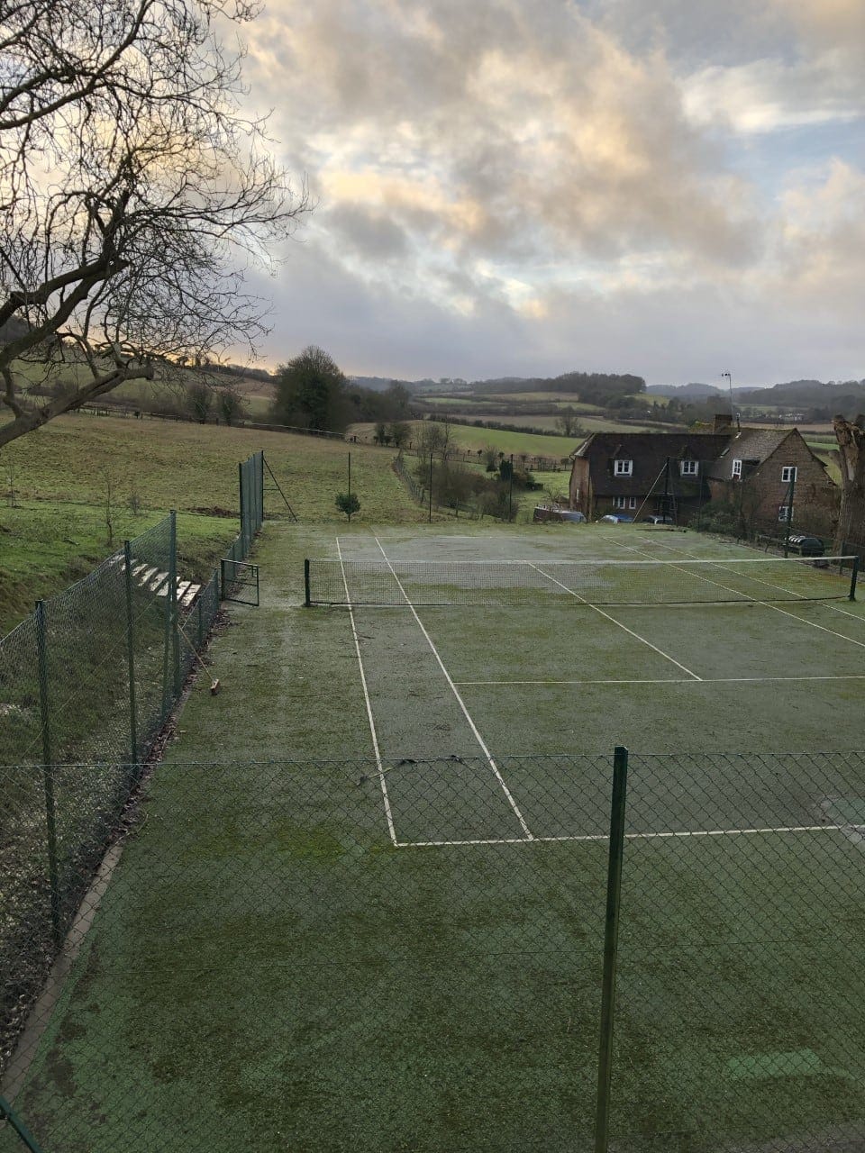 sunny tennis court infront of building