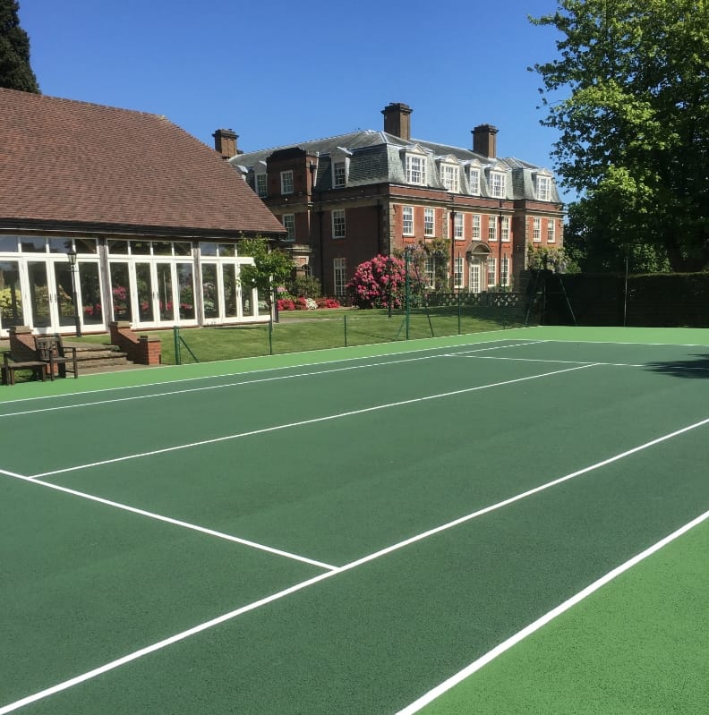 sunny tennis court infront of building